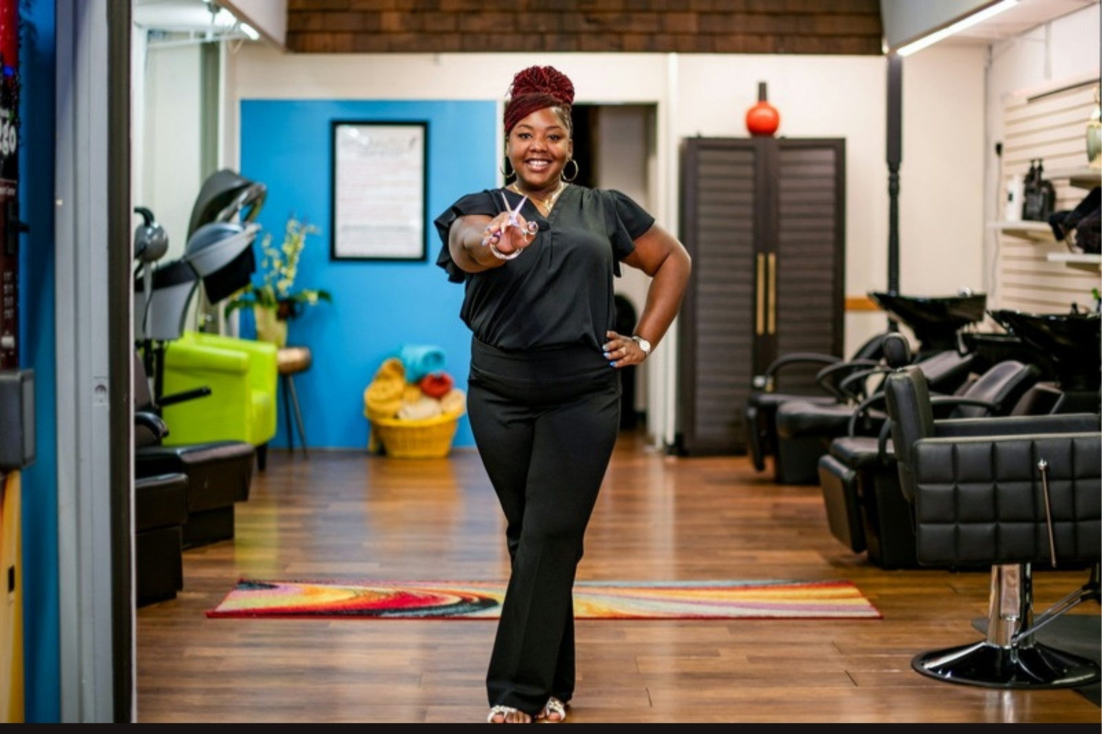 Smiling beauty business owner standing in her own studio, ready for clients